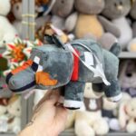 Плюшевий собака з кольоровими елементами.
